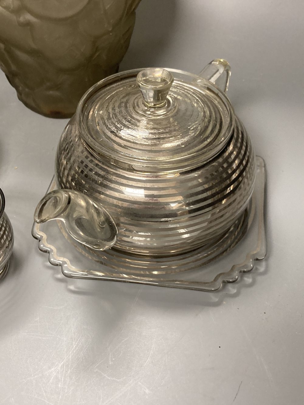 An Art Deco silver stripe and glass tea for two and a frosted leaf design vase, 23.5cm